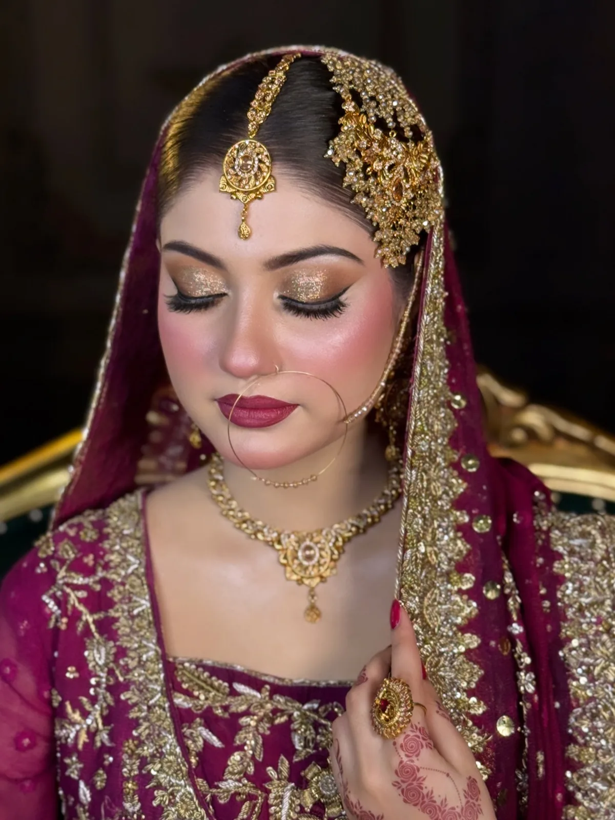 Barat bride in maroon and gold, makeup by Anum Zubair